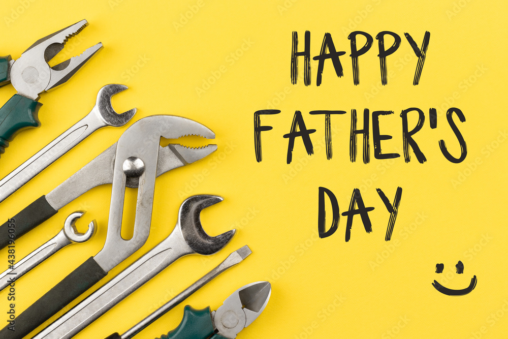 Work tools on bright yellow background with inscription: "happy father's day". Happy fathers day concept or greeting card. Top view, flat lay - obrazy, fototapety, plakaty 