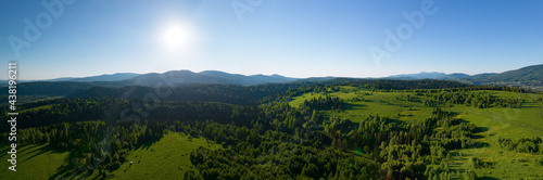 AERIAL VIEW: a large panorama in the Siberian mountains near the small town of Tashtagol. summer view of a forest valley with bright green hills