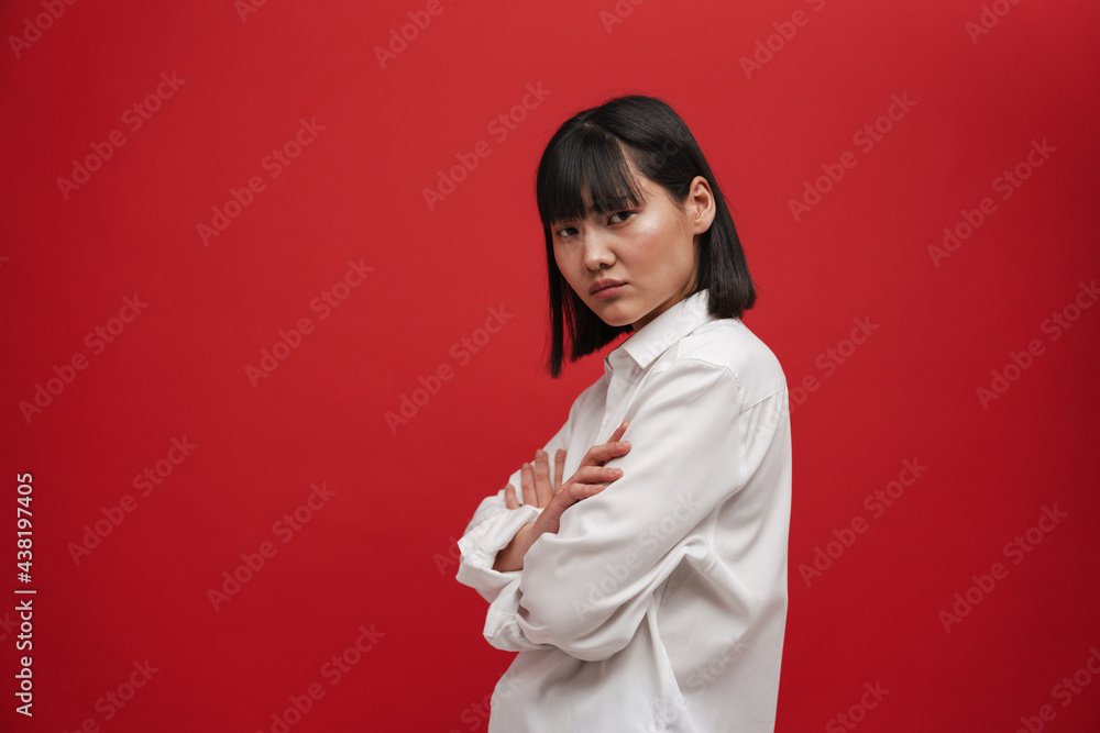 Young asian woman wearing shirt posing with arms crossed