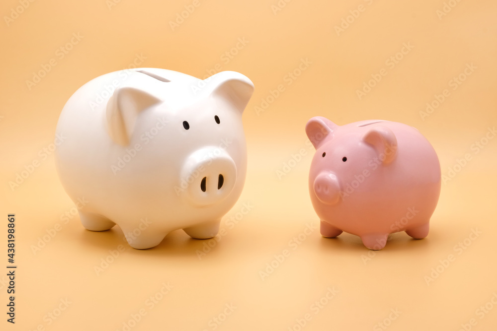 Front view of white and pink piggy bank for money saving isolated on pastel orange background. Front view of white and pink piggy bank for money saving isolated on pastel orange background.