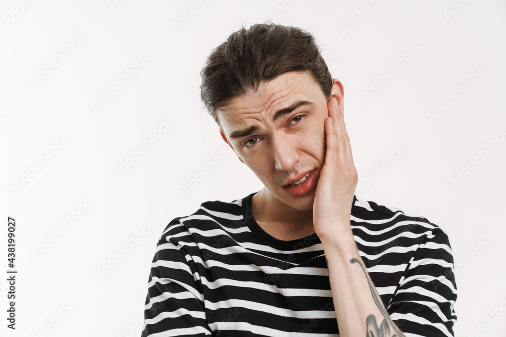 Young white man with toothache posing and looking at camera Young white man with toothache posing and looking at camera