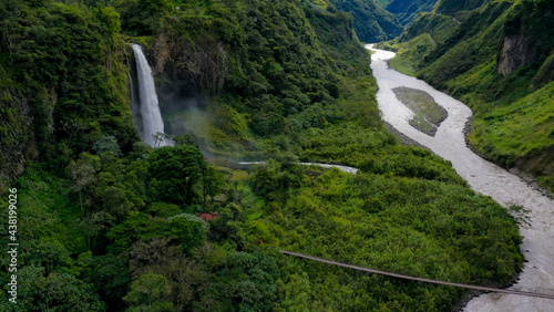 Aerial background of a canyon with a large river and a waterfall at the side
