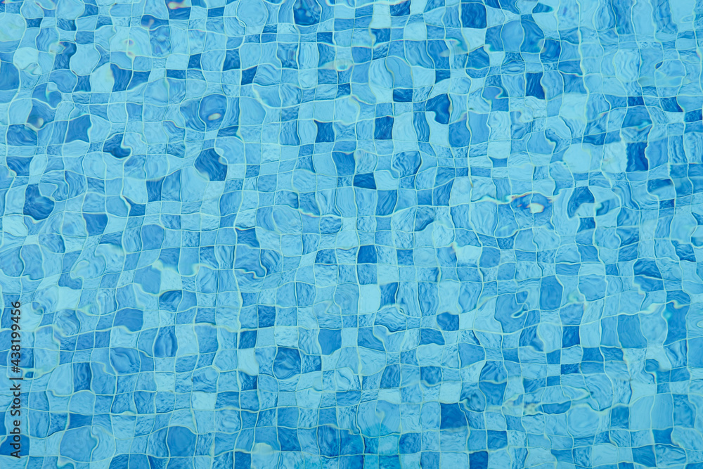 Top view of surface caustics ripped water in swimming pool and flow with waves background. Mosaic wall in blue color for copy space abstract backdrop. Top view of surface caustics ripped water in swimming pool and flow with waves background. Mosaic wall in blue color for copy space abstract backdrop.