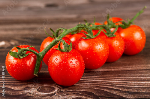 Ripe tomatoes on the wooden table. photo