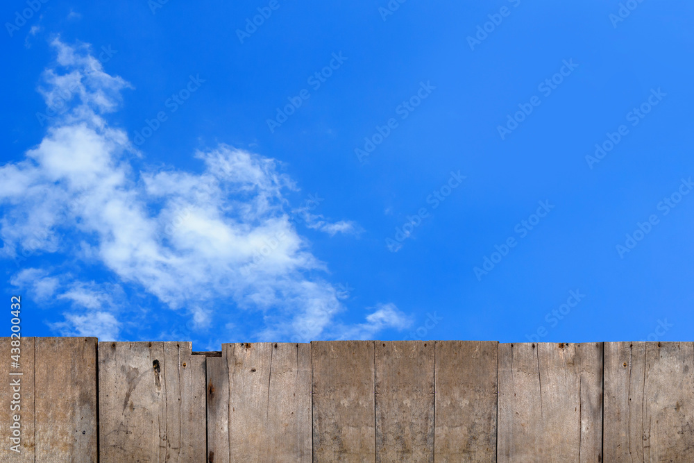 old brown wooden fence with sky background