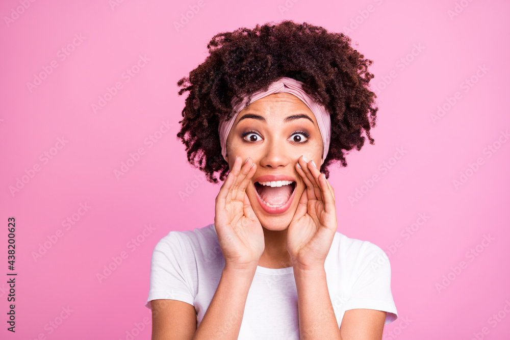 Photo portrait of curly woman shouting breaking news rumour secret isolated on pastel pink color background Photo portrait of curly woman shouting breaking news rumour secret isolated on pastel pink color background