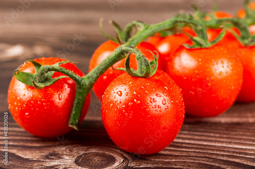 Ripe tomatoes on the wooden table. photo