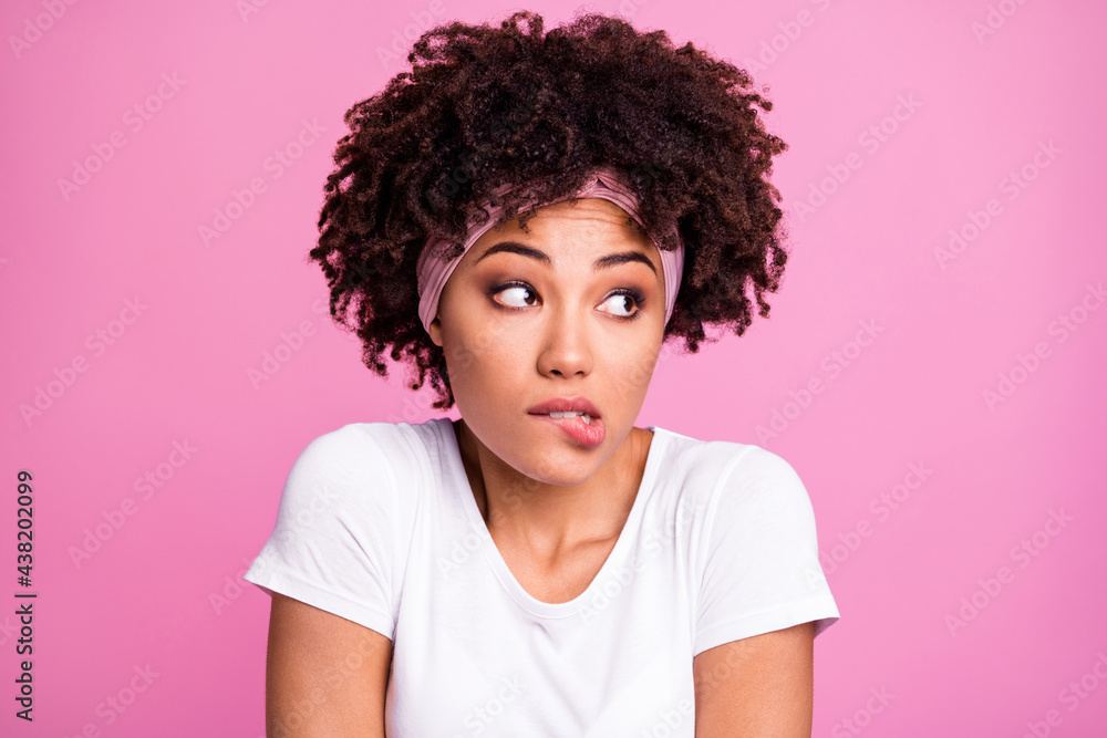 Portrait of attractive worried minded girl looking aside biting lip deciding isolated over pink pastel color background Portrait of attractive worried minded girl looking aside biting lip deciding isolated over pink pastel color background