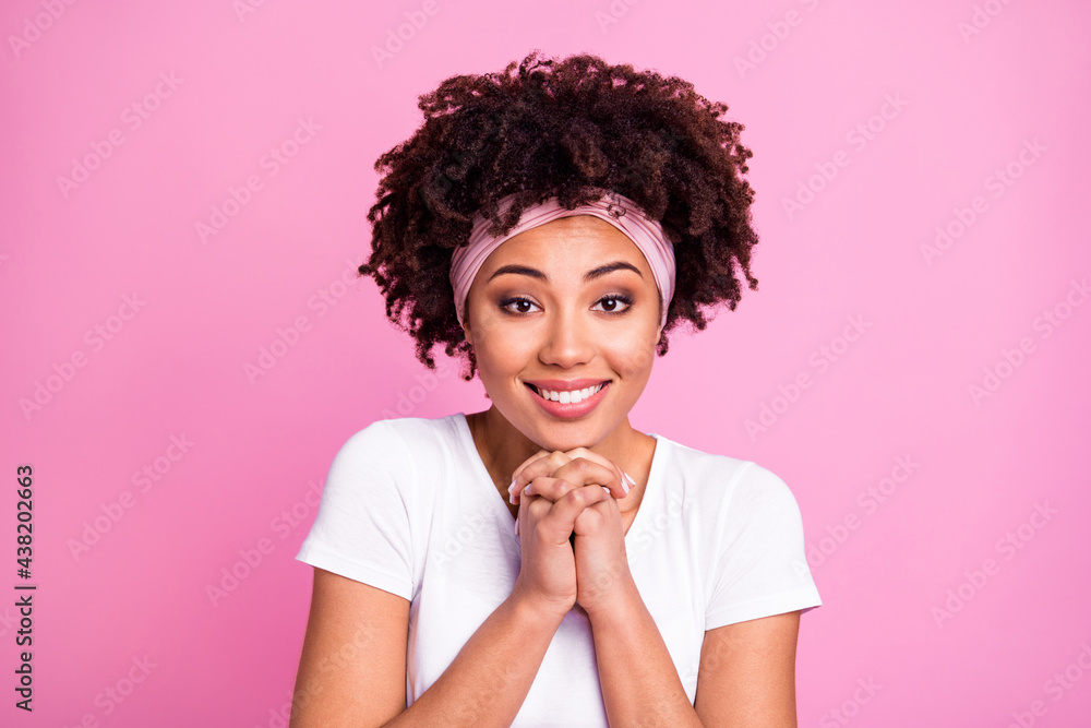 Portrait of brunette optimistic lady hold hands wear white t-shirt hairband isolated on pastel pink background Portrait of brunette optimistic lady hold hands wear white t-shirt hairband isolated on pastel pink background