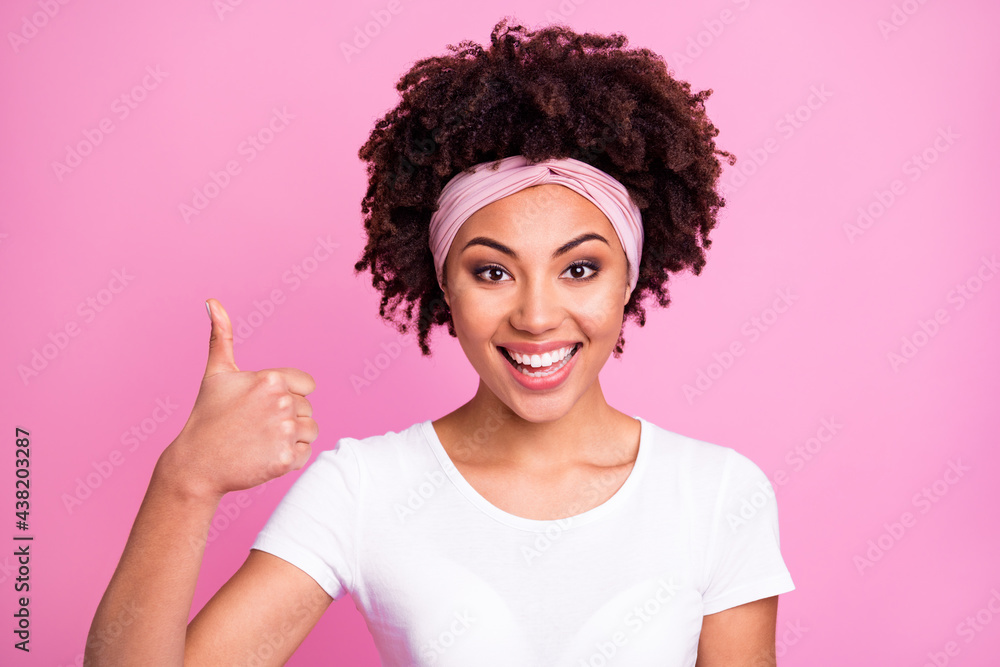 Portrait of brunette optimistic lady show thumb up wear white t-shirt hairband isolated on pastel pink background Portrait of brunette optimistic lady show thumb up wear white t-shirt hairband isolated on pastel pink background