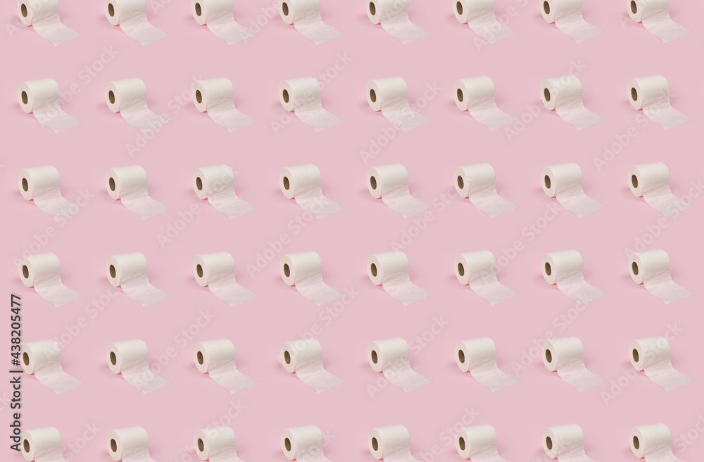 Obraz premium Rolls of white toilet paper on pink background.