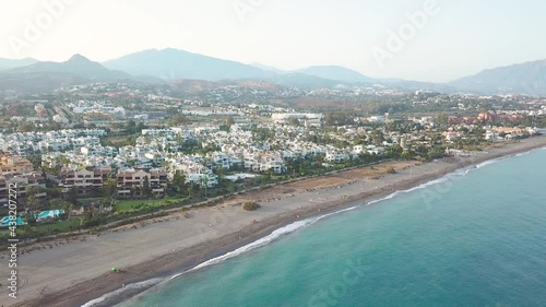 Wallpaper Mural Beautiful sunset over luxury urbanisation, real estate, Costa del Sol, Marbella. In background Sierra Blanca mountains. Drone going backward creating a beautiful panoramic perspective of the village. Torontodigital.ca