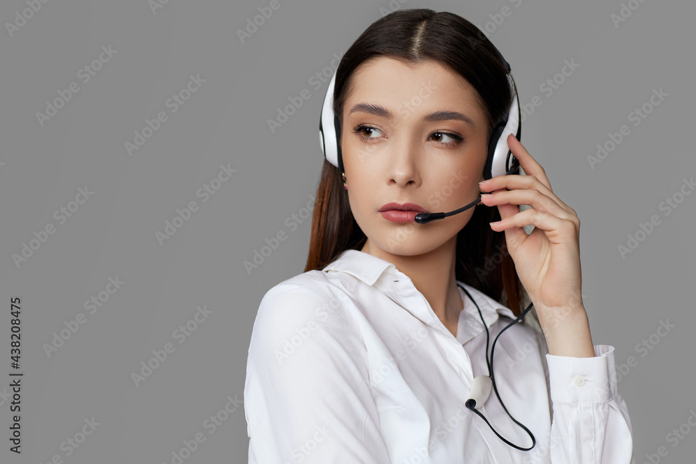 caucasian woman with headset on gray background caucasian woman with headset on gray background
