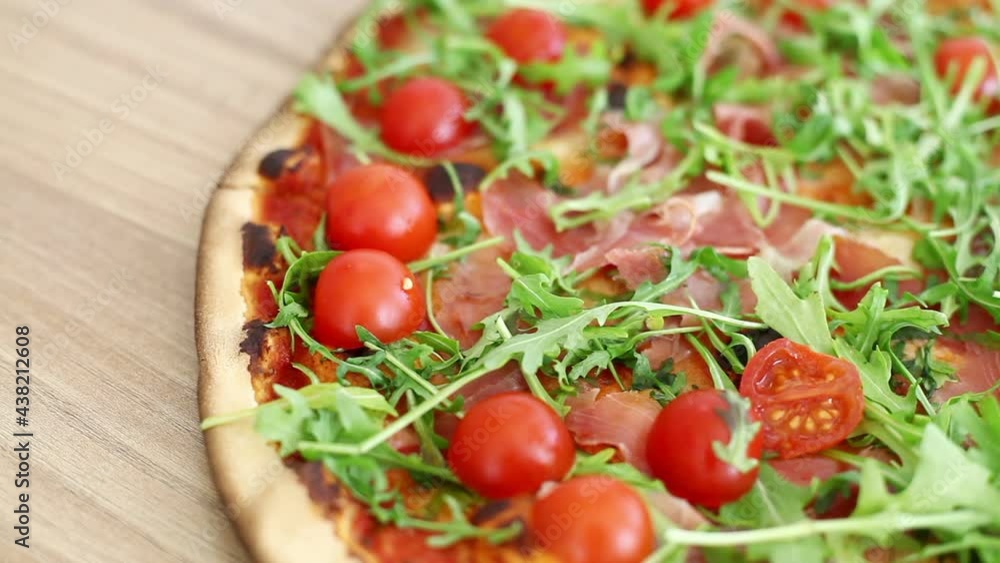 Delicious fast food, pizza with arugula and cherry tomatoes Delicious fast food, pizza with arugula and cherry tomatoes