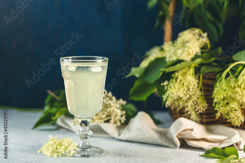 Soft drink with ice cubes from elderflower syrup, juice or champagne in a glass photo