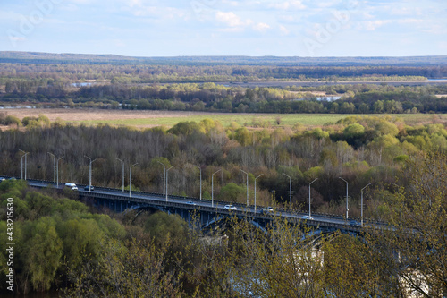 View of a flat area with a river and a bridge over the river on a spring day. A panorama that opens from the observation deck in the city of Vladimir in Russia.