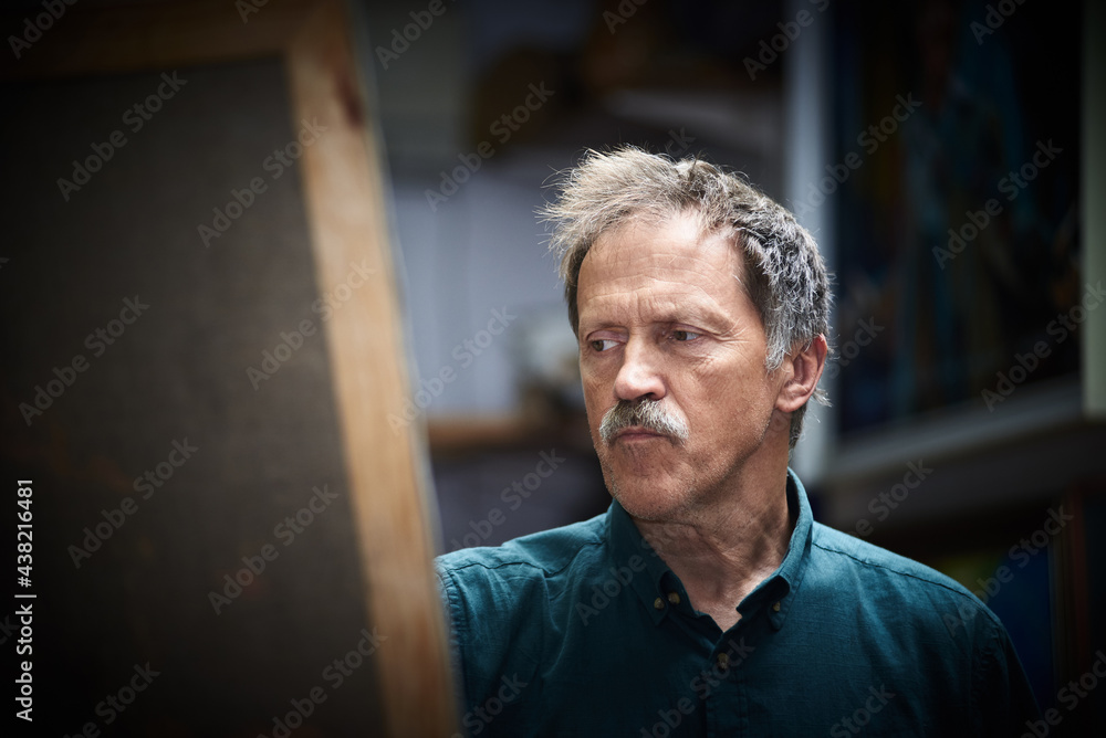 Fototapeta premium Senior man artist painting in art studio