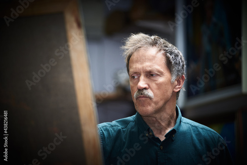 Senior man artist painting in art studio