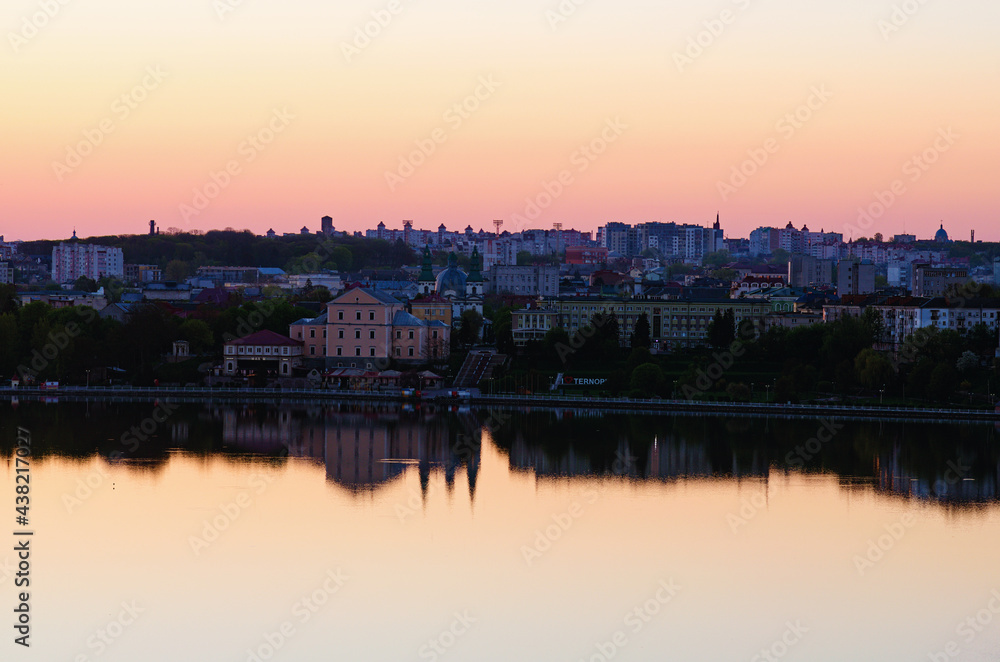 Ternopil, Ukraine-May, 11,2021:Aerial morning landscape view of Ternopil downtown. City lake, embankment, Taras Shevchenko Park and ancient building during spring sunrise. Romantic and peaceful scene