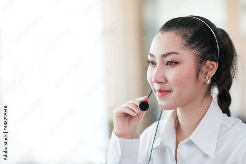 Asian call center woman worker at work. Smiling female customer support operator with headset working in the office. Contact center and customer service by headphone concept Asian call center woman worker at work. Smiling female customer support operator with headset working in the office. Contact center and customer service by headphone concept
