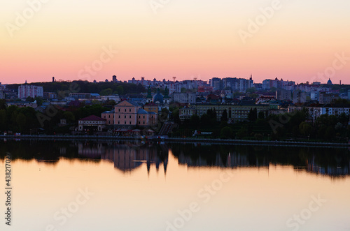 Ternopil, Ukraine-May, 11,2021:Aerial morning landscape view of Ternopil downtown. City lake, embankment, Taras Shevchenko Park and ancient building during spring sunrise. Romantic and peaceful scene