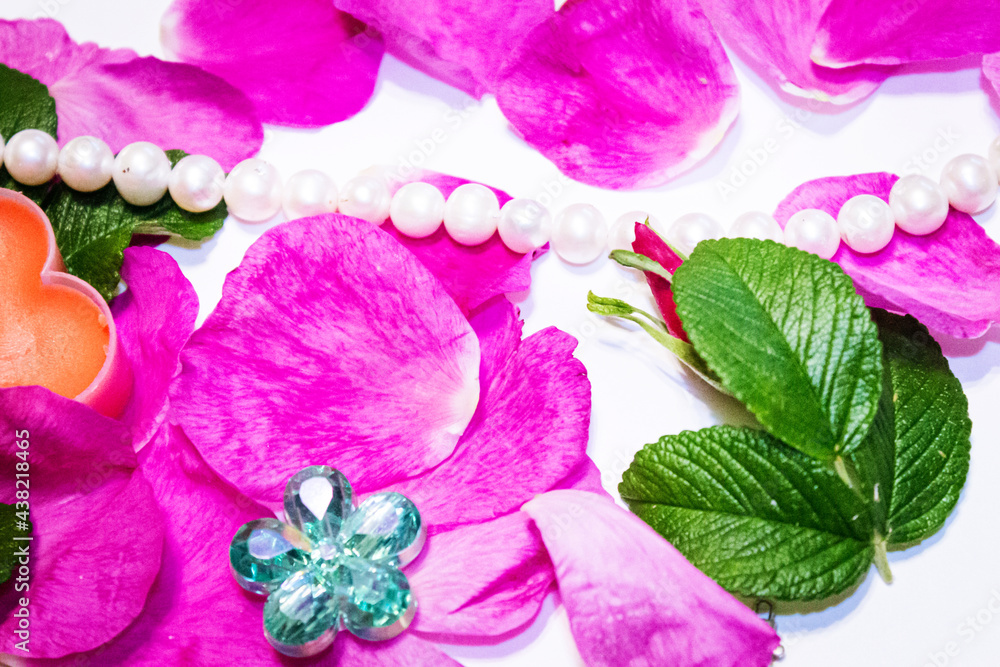 Romantic background. On a white sheet rose petals, decorations and candles. Romantic background. On a white sheet rose petals, decorations and candles.