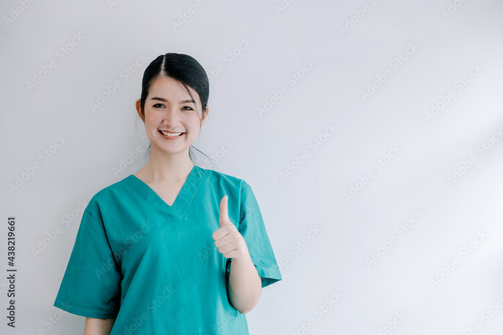 Beautiful professional nurse raises hands gestures thumbs up and looks straight at the camera with a happy smiling expression on a white background ,nursing trust physician Beautiful professional nurse raises hands gestures thumbs up and looks straight at the camera with a happy smiling expression on a white background ,nursing trust physician
