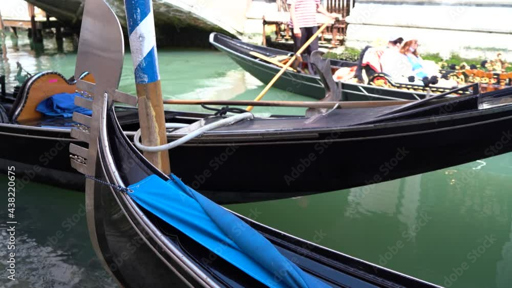 Venice, Italy - gondolas and gondoliers in the Grand Canal near the Rialto Bridge, in the San Marco Basin and between the canals of the lagoon city Venice, Italy - gondolas and gondoliers in the Grand Canal near the Rialto Bridge, in the San Marco Basin and between the canals of the lagoon city