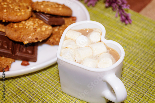 peanuts and chocolate close-up cookies. A cup of coffee with marshmallows.
