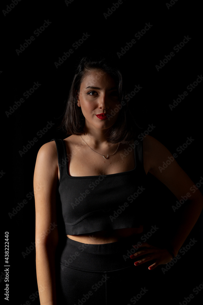 Portrait of attractive a young woman with cinematic lighting. Woman wearing a suspender bodysuit. Half naked sexy woman. Vertical shot. Portrait of attractive a young woman with cinematic lighting. Woman wearing a suspender bodysuit. Half naked sexy woman. Vertical shot.