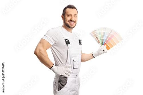 House decorator in a white uniform holding a color palette photo