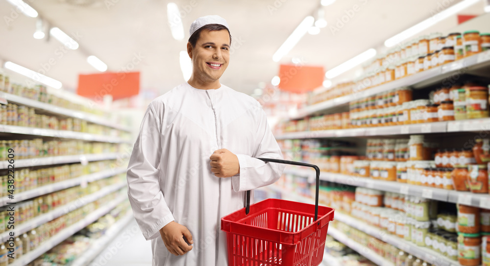 Young man in ethnic clothes holding a shopping basket