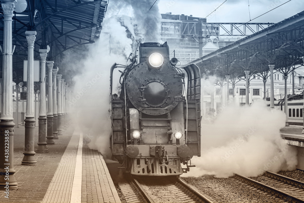 Retro train departs from the platform. Stock Photo | Adobe Stock