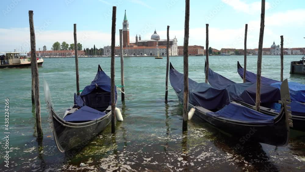 Venice, Italy - gondolas and gondoliers in the Grand Canal near the Rialto Bridge, in the San Marco Basin and between the canals of the lagoon city Venice, Italy - gondolas and gondoliers in the Grand Canal near the Rialto Bridge, in the San Marco Basin and between the canals of the lagoon city