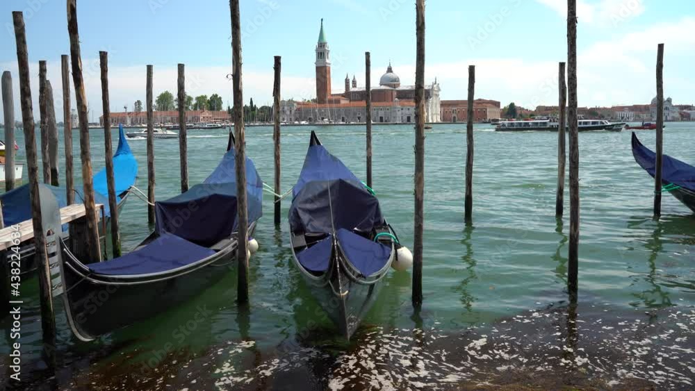 Venice, Italy - gondolas and gondoliers in the Grand Canal near the Rialto Bridge, in the San Marco Basin and between the canals of the lagoon city Venice, Italy - gondolas and gondoliers in the Grand Canal near the Rialto Bridge, in the San Marco Basin and between the canals of the lagoon city