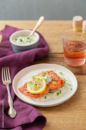 Salmon with lemon and tarter sauce and rose photo