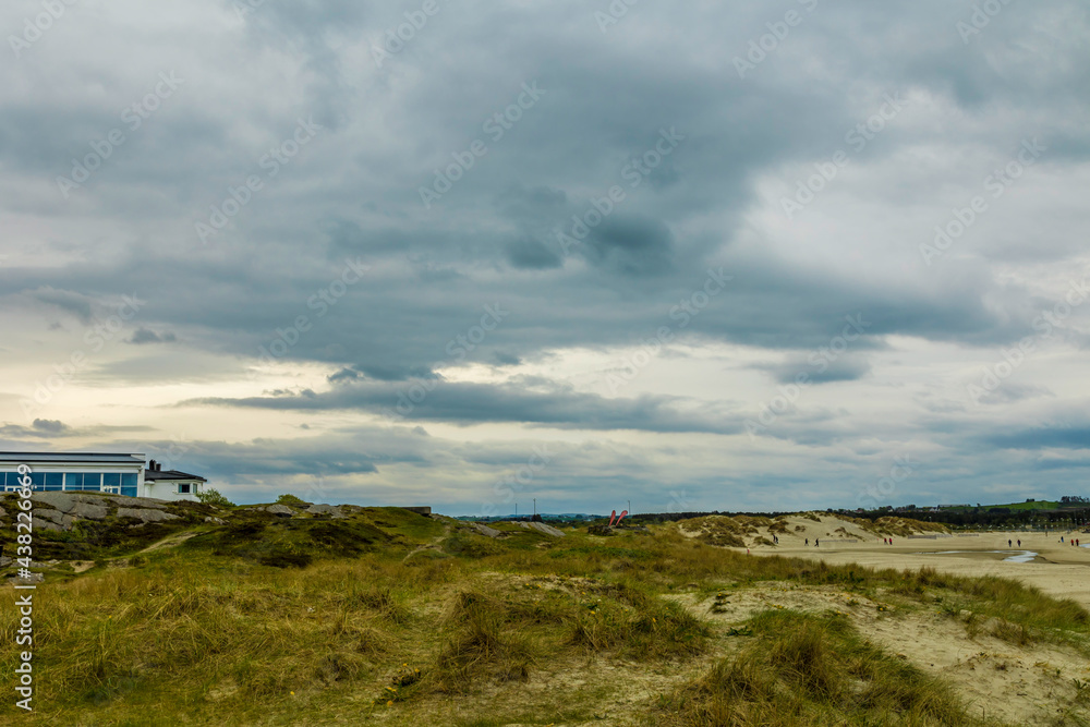 Scenic View Of Beach Against Cloudy Sky
