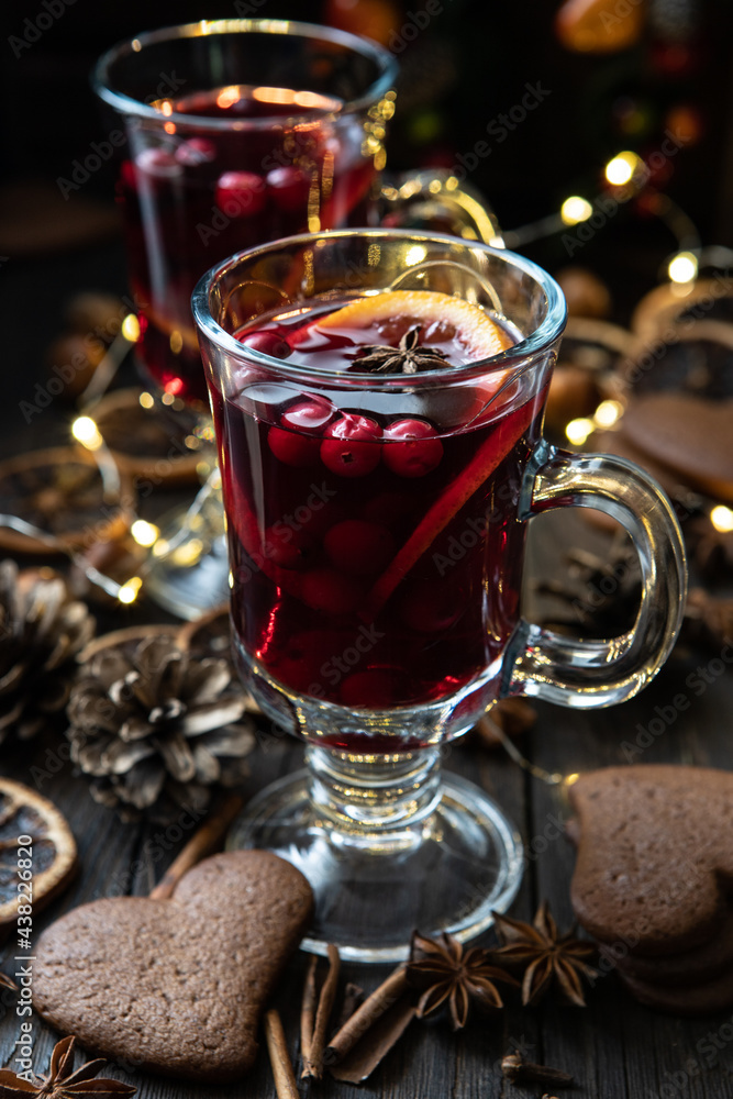 Christmas hot drink with citrus and cranberry in glass. Christmas and winter warming beverage Christmas hot drink with citrus and cranberry in glass. Christmas and winter warming beverage