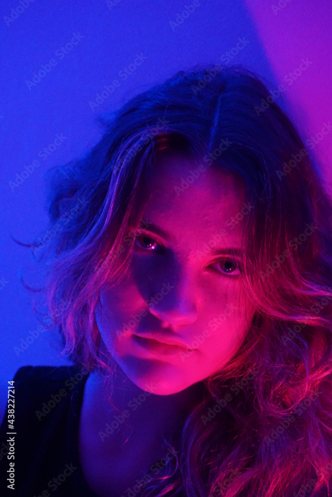 teenager in blue with neon ights