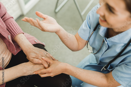 Close-Up Of A Nurse Holding Hands Of Senior Female Patient