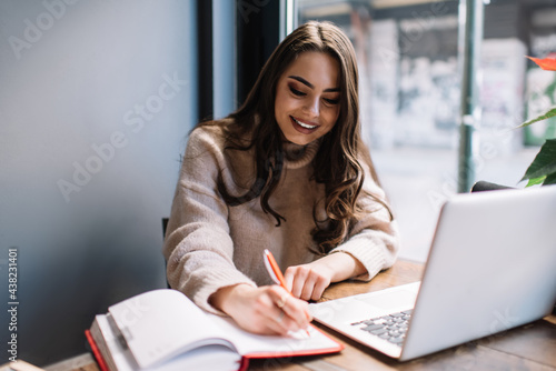 Cheerful young woman working in cafe