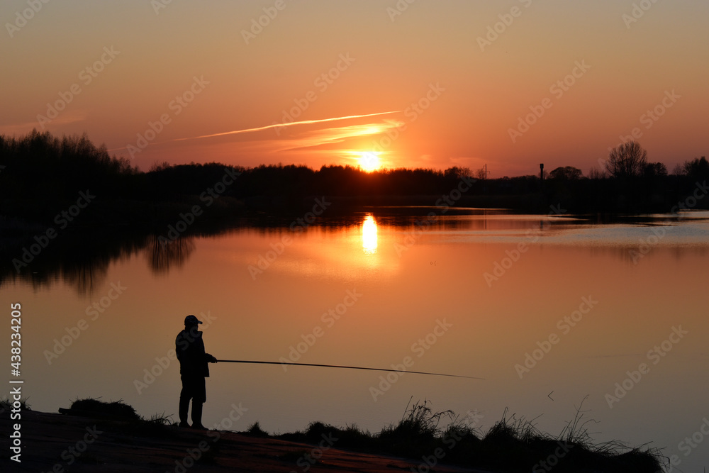 Photo of a fisherman at sunset