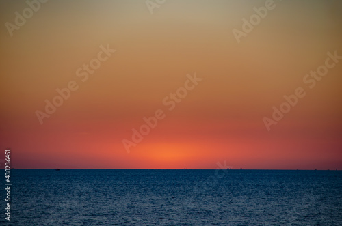 Beautiful sunset on the sea with soft focus and noise. © Phatthida
