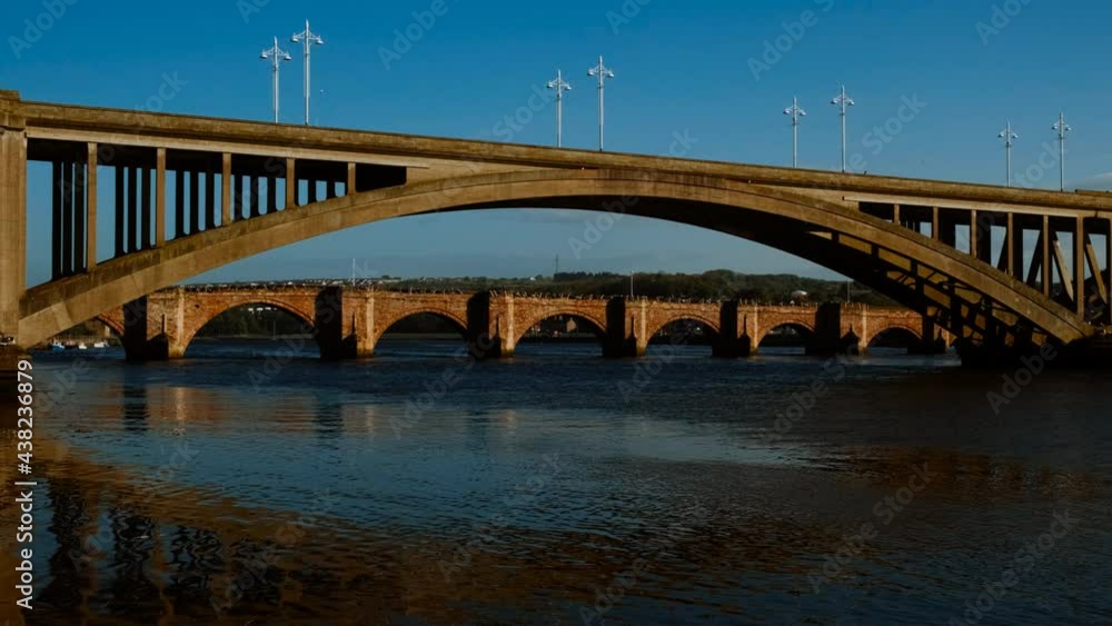 Sunset view of Royal Tweed Bridge and Berwick Bridge, also known as Old Bridge in Berwick-upon-Tweed in Northumberland, England, UK Sunset view of Royal Tweed Bridge and Berwick Bridge, also known as Old Bridge in Berwick-upon-Tweed in Northumberland, England, UK