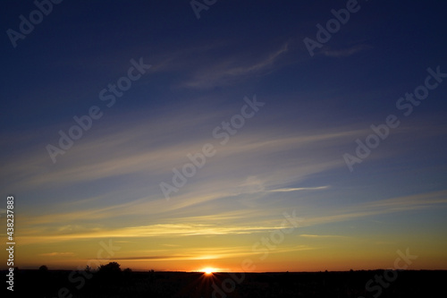 Summer sunset on the background of light cirrus clouds