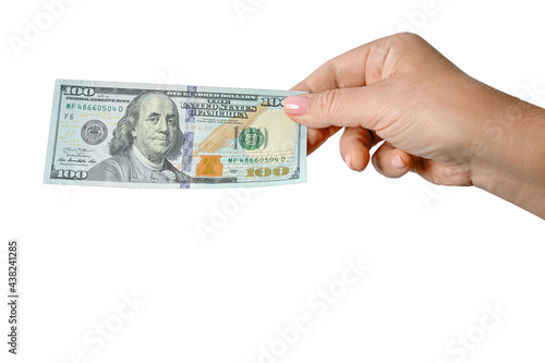 Female hand holds a banknote of 100 American dollars in cash, isolated on white background. 100 US dollars banknote