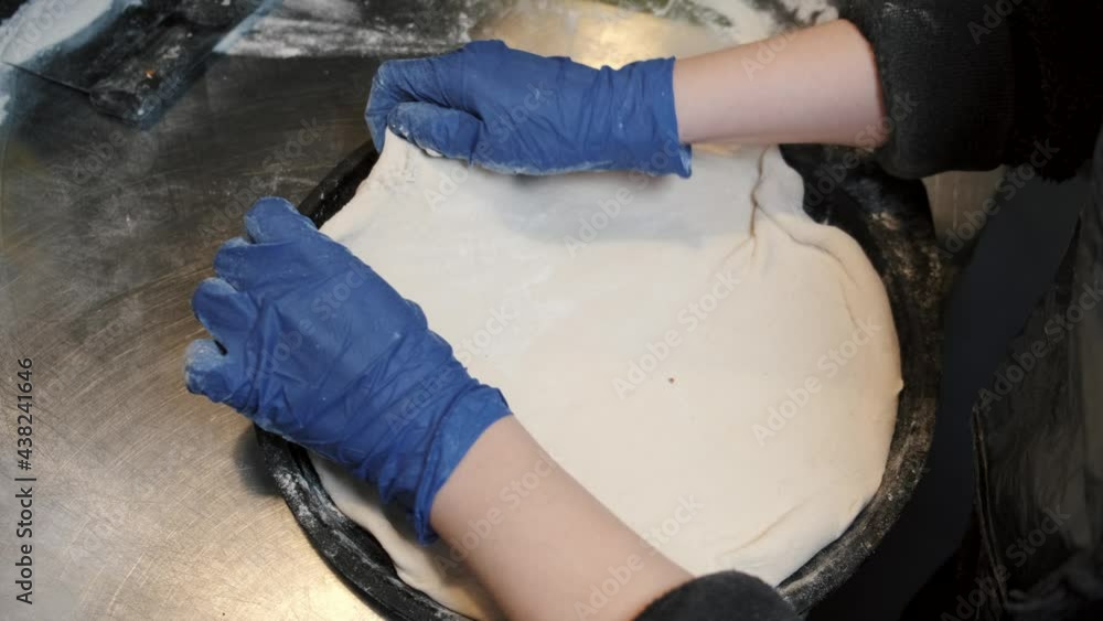 Rolling the pastry dough on a flat surface Rolling the pastry dough on a flat surface