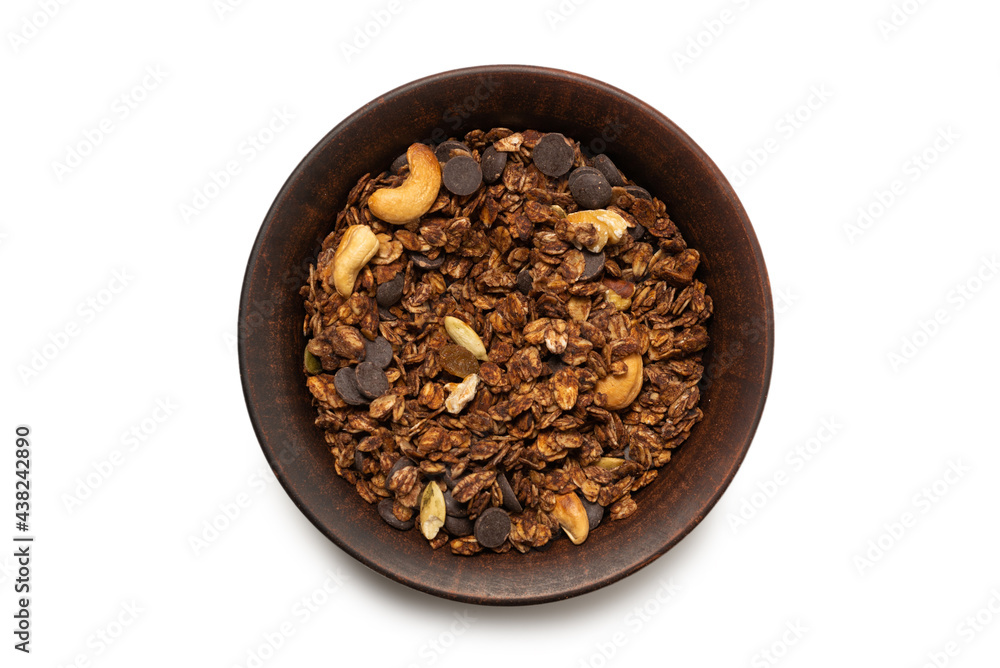 Chocolate granola cereal with nuts in a bowl background. Chocolate granola cereal with nuts in a bowl background.
