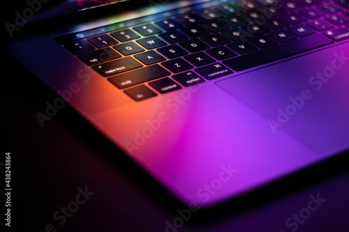 laptop with colourful glowing reflection
