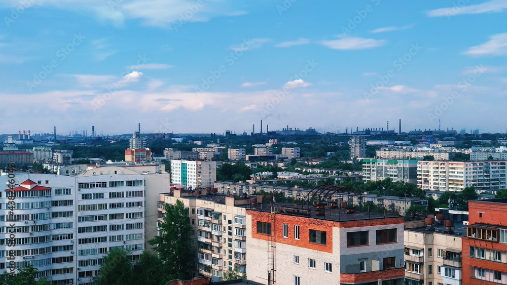 Panorama of an industrial city and chimneys of factories on the horizon
